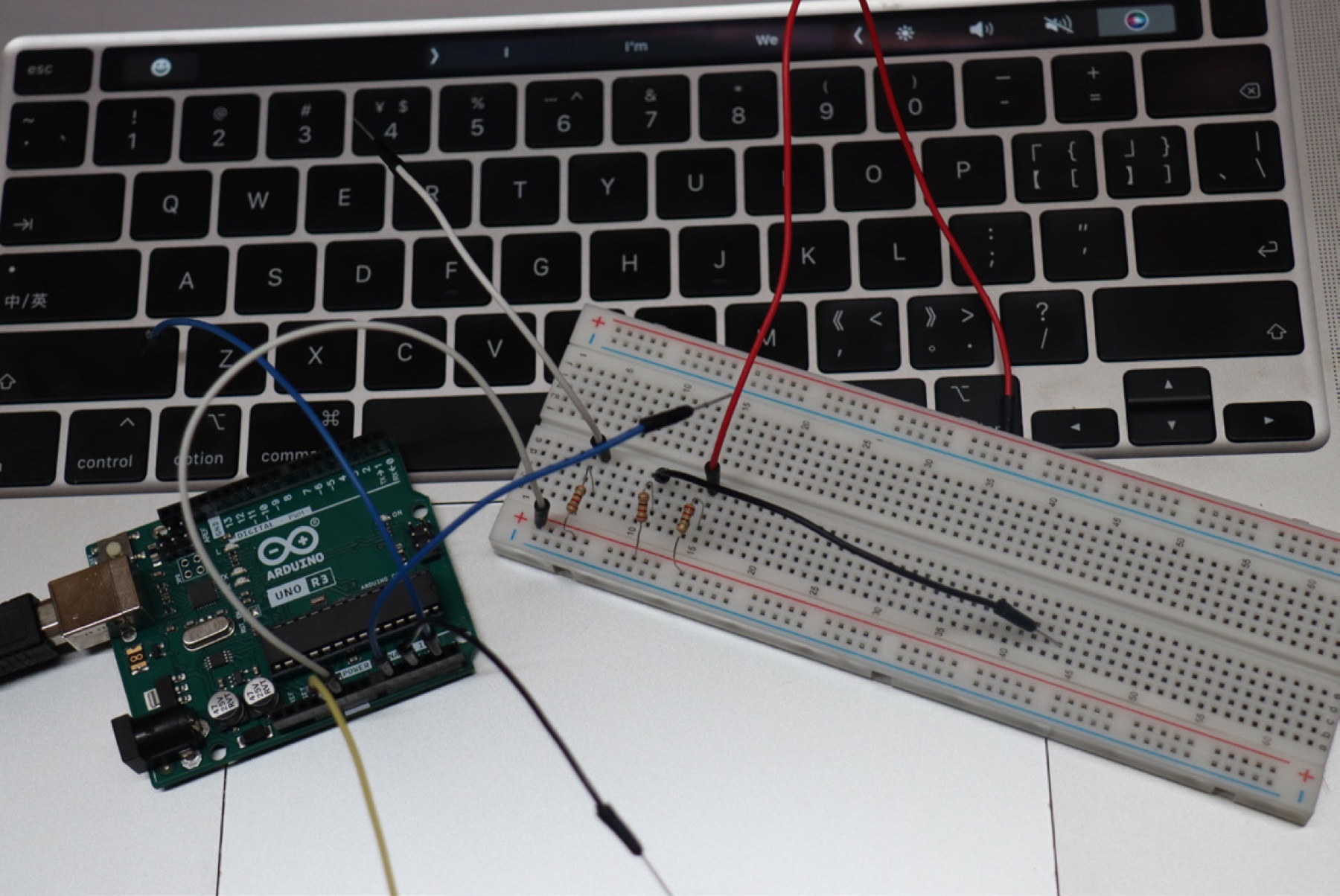 Arduino Uno, breadboard, resistors and wires used in the sensing prototype